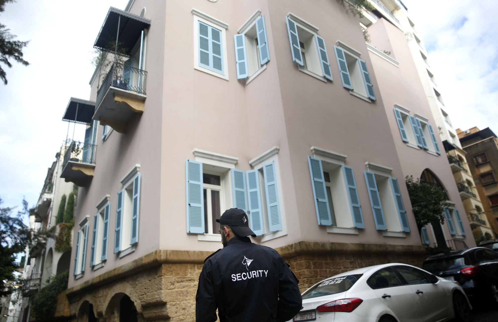 A private security guard stands outside the house of ex-Nissan chief Carlos Ghosn in Beirut Sunday. | AP