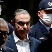 Former Nissan Chariman Carlos Ghosn leaves the Tokyo Detention House last April. | REUTERS