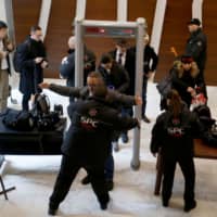 Security personnel check journalists ahead of a news conference by former Nissan Chairman Carlos Ghosn in Beirut on Wednesday. | REUTERS