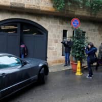 Journalists enter the garage of a house believed to belong to former Nissan Chairman Carlos Ghosn in Beirut on Thursday. | REUTERS