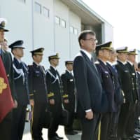 Defense Minister Taro Kono (center) attends a sendoff ceremony for two Maritime Self-Defense Force P-3C patrol planes at Naha airport in Okinawa Prefecture on Saturday. | KYODO