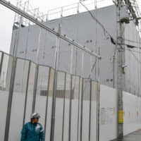 Demolition work starts at the fire-damaged Kyoto Animation Co. studio on Jan. 7. | KYODO