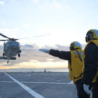 An MH-60S helicopter is launched from the flight deck of U.S. 7th Fleet flagship USS Blue Ridge in Sagami Bay, south of Kanagawa Prefecture, on Tuesday. | U.S. NAVY
