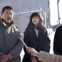 Hokkaido University of Education professor Hibiki Momose (center) and other colleagues of Yuan Keqin, a professor of East Asian political history who has been missing for the past six months, explain a petition they submitted to the Chinese Consulate General in Sapporo on Thursday. | KYODO