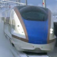 A Hokuriku shinkansen train travels on a snowy day. | WEST JAPAN RAILWAY CO. / VIA KYODO