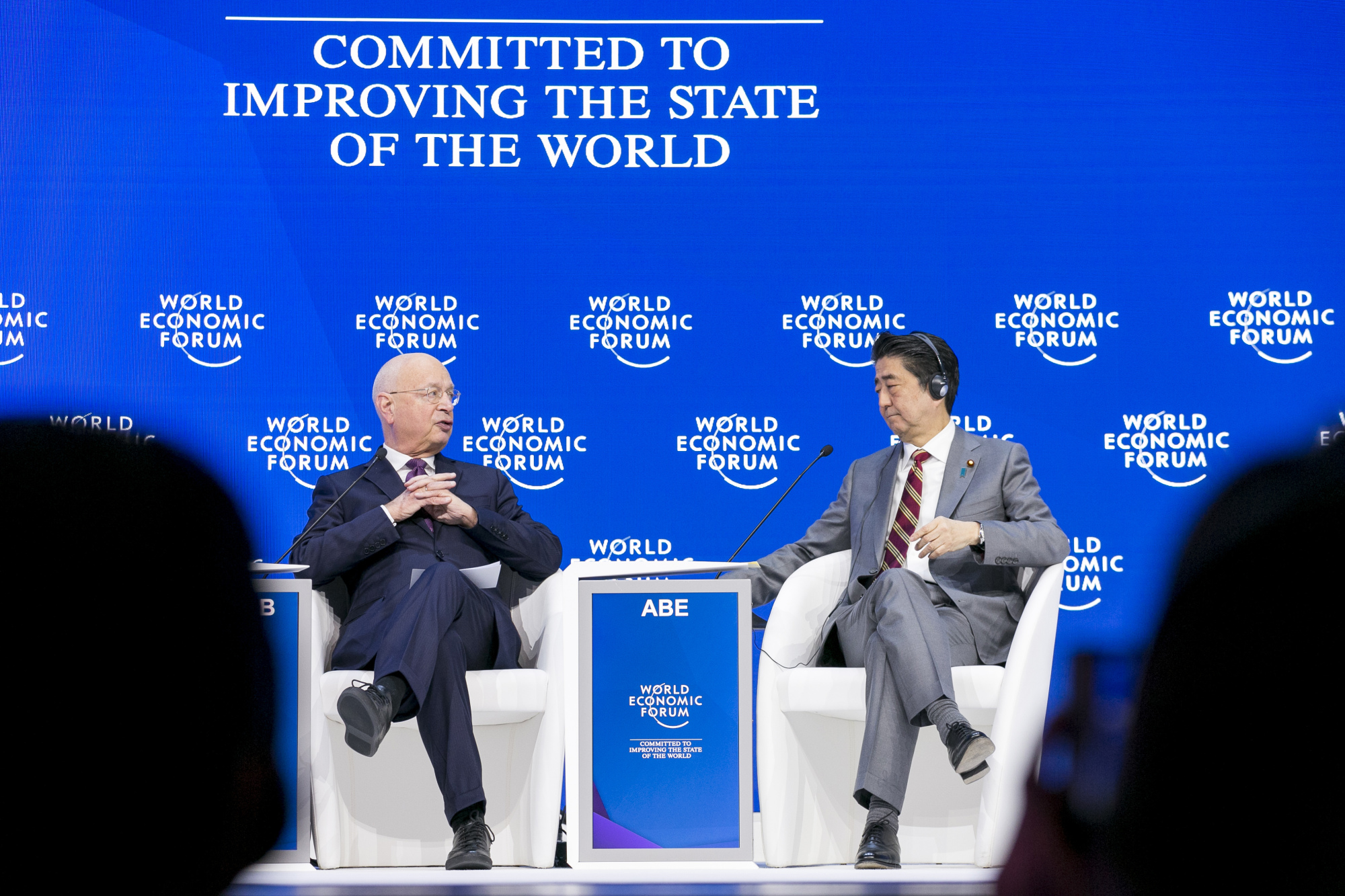 Klaus Schwab, founder and executive chairman of the World Economic Forum (WEF), speaks with Prime Minister Shinzo Abe during a session at the 2019 WEF Annual Meeting on Jan. 23, 2019.  WORLD ECONOMIC FORUM | THE JAPAN TIMES / GETTY IMAGES