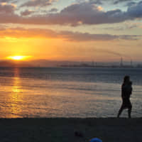 Smeared skies: The view from the beach on Shiraishi Island looks out across the Seto Inland Sea and onto several chimneys belching black smoke into the air. | AMY CHAVEZ