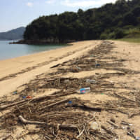 Drifting onto the shore: Plastic garbage washes ashore with more natural debris prompting the residents of Shiraishi Island to take part in regular beach cleanups. | AMY CHAVEZ