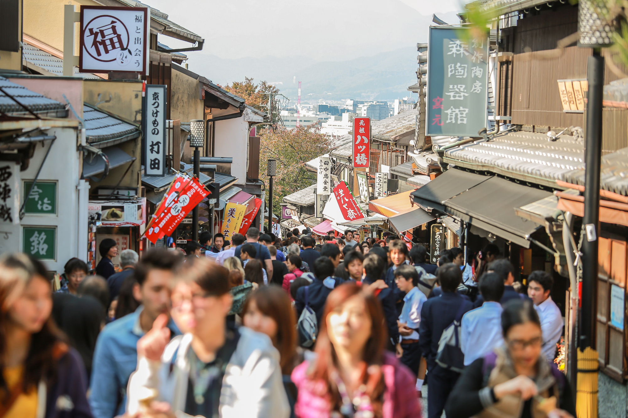Jumble in the urban jungle: Tourists crowd the street in Kyoto where local residents have become increasingly irked by what some are calling 'overtourism.' | GETTY IMAGES