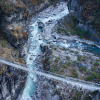 River crossing: A suspension bridge runs over the milky blue waters of the Dudh Kosi River, on the lower part of the trek. | OSCAR BOYD