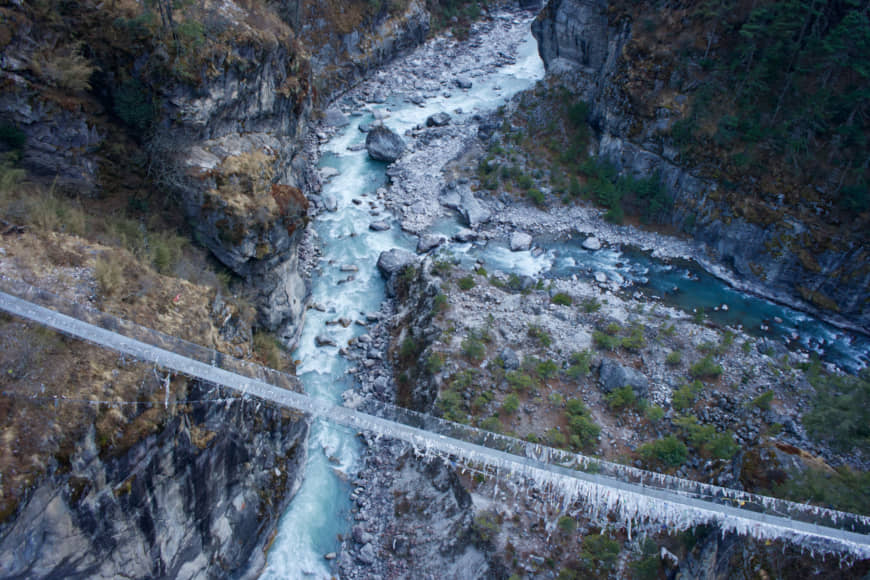 River crossing: A suspension bridge runs over the milky blue waters of the Dudh Kosi River, on the lower part of the trek. | OSCAR BOYD