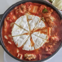 Cheese, please: This nabe (hot pot) features an entire wheel of Camembert cheese, which melts to form a rich, gooey sauce. | MAKIKO ITOH