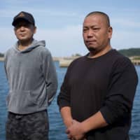 Fishermen Yasushi Matsumoto (left) and Katsuyuki Sakaguchi have grown up on the island and have been working at Katsumoto Fisheries for much of their lives. | OSCAR BOYD
