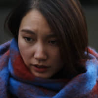 Journalist Shiori Ito emerges victorious from the Tokyo District Court on Dec. 18. | AP