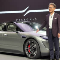 Sony President and CEO Kenichiro Yoshida unveils the Vision-S prototype electric vehicle at a Jan. 6 press conference for the CES show in Las Vegas. | WAICHI SEKIGUCHI