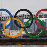 A barge hauls the Olympic logo on Saturday to install in Tokyo\'s Odaiba district. The global spotlight will shine on Japan this summer when it hosts the Olympics and Paralympics. | AFP-JIJI