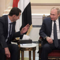 Russian President Vladimir Putin meets with his Syrian counterpart, Bashir Assad, on Tuesday following the death of Iranian Gen. Qassem Soleimani. | AP