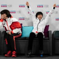 Yuma Kagiyama reacts alongside coach Misao Sato after winning the gold medal at the Winter Youth Olympics in Lausanne, Switzerland, on Sunday. | AFP-JIJI