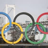 An monument depicting the Olympic rings is seen in Tokyo’s Odaiba waterfront district on Friday. Similar structures are scheduled to placed in other parts of the city as well. | KYODO