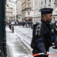 Police cordon off a road outside the Blackrock Inc. offices following a climate activist protest inside the building in Paris on Monday. BlackRock\'s Paris office was briefly barricaded by climate activists who sprayed red paint on the floors and covered the walls with graffiti before leaving the premises of the world\'s largest asset manager. | BLOOMBERG