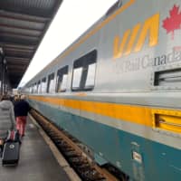 Travelers walk by a VIA train in Ottawa in December. Canadian Prime Minister Justin Trudeau warned Tuesday against the use of force to resolve a rail blockade sparked by indigenous protesters and now in its second week. | AFP-JIJI