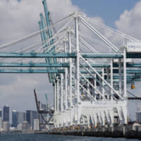 Large cranes to unload containerships are shown at PortMiami in Miami last July. The U.S. trade deficit fell for the first time in six years in 2019 as President Donald Trump hammered China with import taxes. The Commerce Department said Wednesday the gap between what the United States sells and what it buys abroad fell 1.7 percent last year to &#36;616.8 billion. | AP