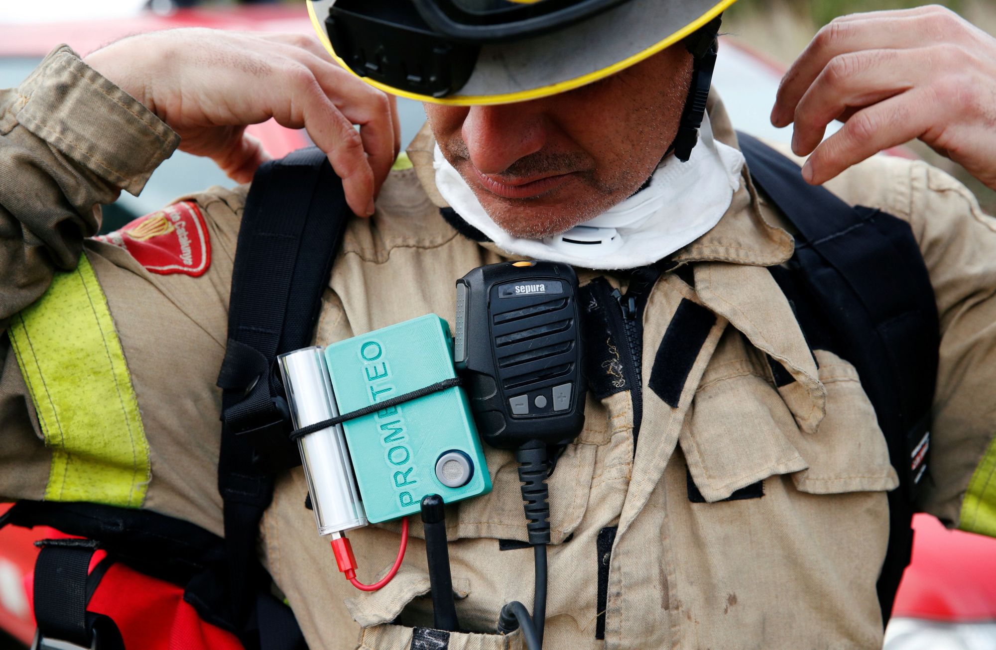 A Prometeo monitoring device, by IBM, is worn by a firefighter during a prescribed burn of the forest in Olivella, south of Barcelona, Spain, Feb. 11. | REUTERS