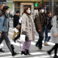 An intersection in the upscale Ginza district of Tokyo on Feb. 15. The world economy may be heading for its worst performance since 2009 amid worries over COVID-19. | BLOOMBERG