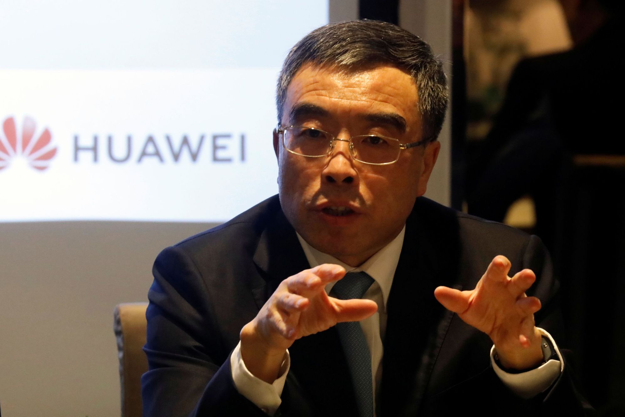 Huawei Technologies Chairman Liang Hua speaks during a news conference in Paris Thursday. | REUTERS