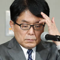Japan Post Holdings Co. President Hiroya Masuda faces the media during a news conference Friday in Tokyo over the discovery of more improper insurance sales. | KYODO