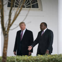 U.S. President Donald Trump walks with Uhuru Kenyatta, Kenya\'s president (right), outside of the White House in Washington on Thursday. Trump is ramping up his appeals to African Americans, including a State of the Union speech on Tuesday that illustrated his campaign\'s effort to lure enough black voters from the Democratic Party to secure his re-election. | BLOOMBERG