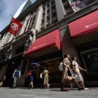 Pedestrians walk past a department store operated by Takashimaya Co. in Nihonbashi district of Tokyo in September 2018. Major department stores reported drops in Lunar New Year sales this year in the wake of the coronavirus outbreak in China. | BLOOMBERG