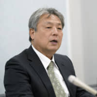 Mitoshi Matsumoto, former owner of a Seven-Eleven store in Higashiosaka, Osaka Prefecture, holds a news conference in Osaka on Wednesday after filing a lawsuit with the Osaka District Court against chain operator Seven-Eleven Japan Co. | KYODO