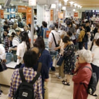 A consumption tax hike last October and sluggish sales of winter items pushed down household spending for the third consecutive month in December, government data shows. | KYODO
