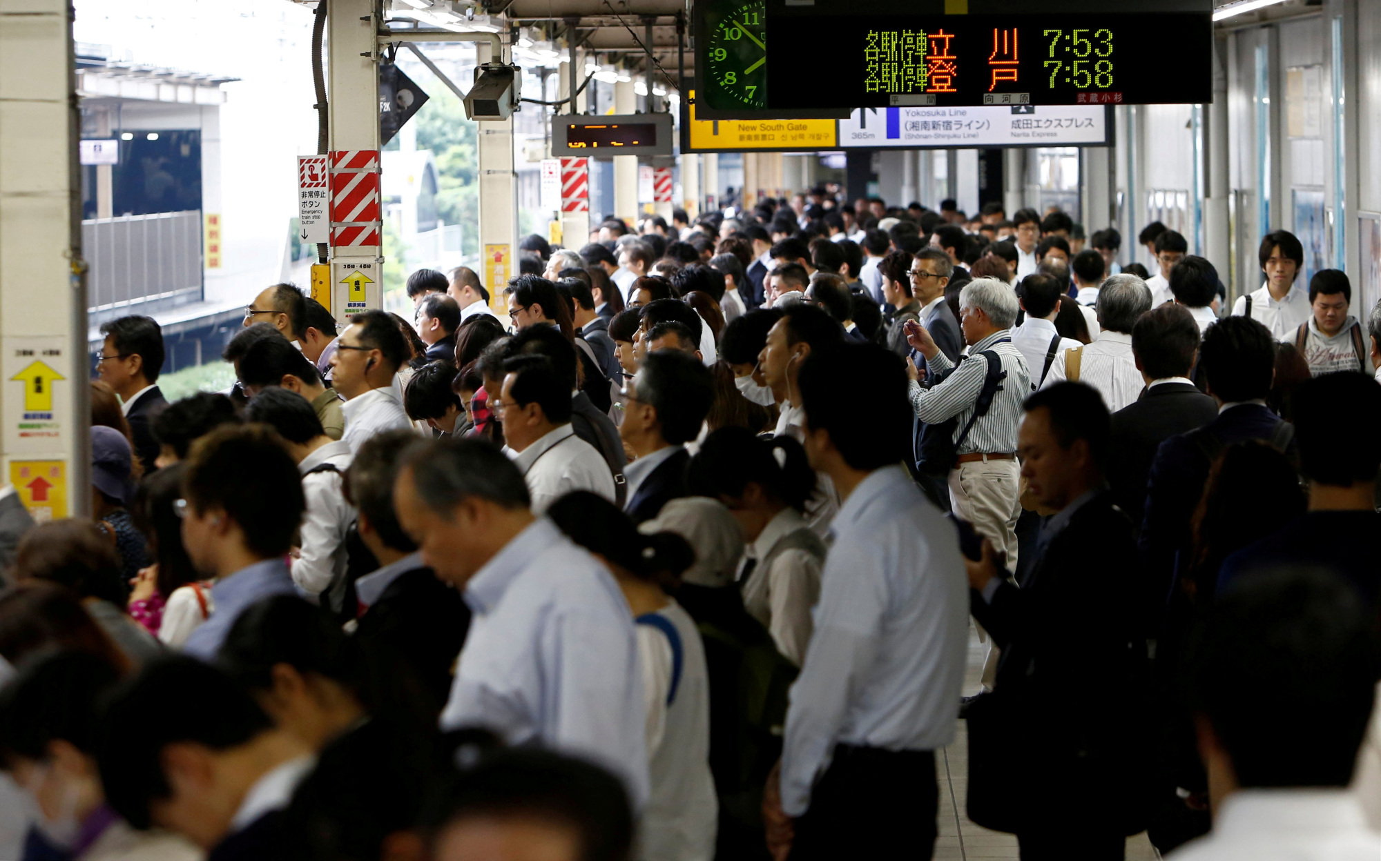 Passengers wait for a train in Kawasaki in June 2017. | REUTERS