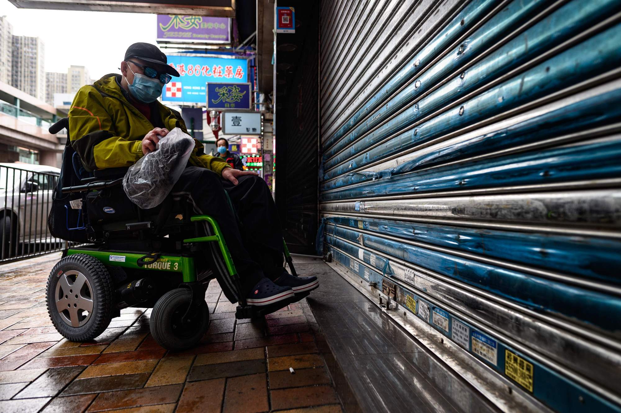 A patient stops in front of a shuttered Hong Kong pharmacy on Feb. 13. | AFP-JIJI