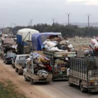 Vehicles carry belongings of internally displaced Syrians from the western Aleppo countryside, in Hazano near Idlib, Syria, Feb. 11. | REUTERS