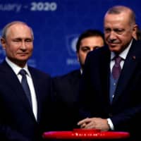 Turkish President Tayyip Erdogan and Russian President Vladimir Putin (right) attend a ceremony marking the formal launch of the TurkStream pipeline, which will carry Russian natural gas to southern Europe through Turkey, in Istanbul Jan. 8. | REUTERS