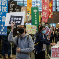 Medical workers submit petition letters during a protest at the Hospital Authority\'s head office in Hong Kong on Feb. 4. | BLOOMBERG