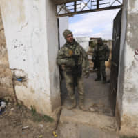 Turkish soldiers stand in a house in the countryside in the Syrian province of Idlib Monday. Turkey said it hit back at Syrian government forces on Monday, after \"intense\" Syrian shelling killed five of its soldiers and wounded five others in Syria\'s northern Idlib province. | AP