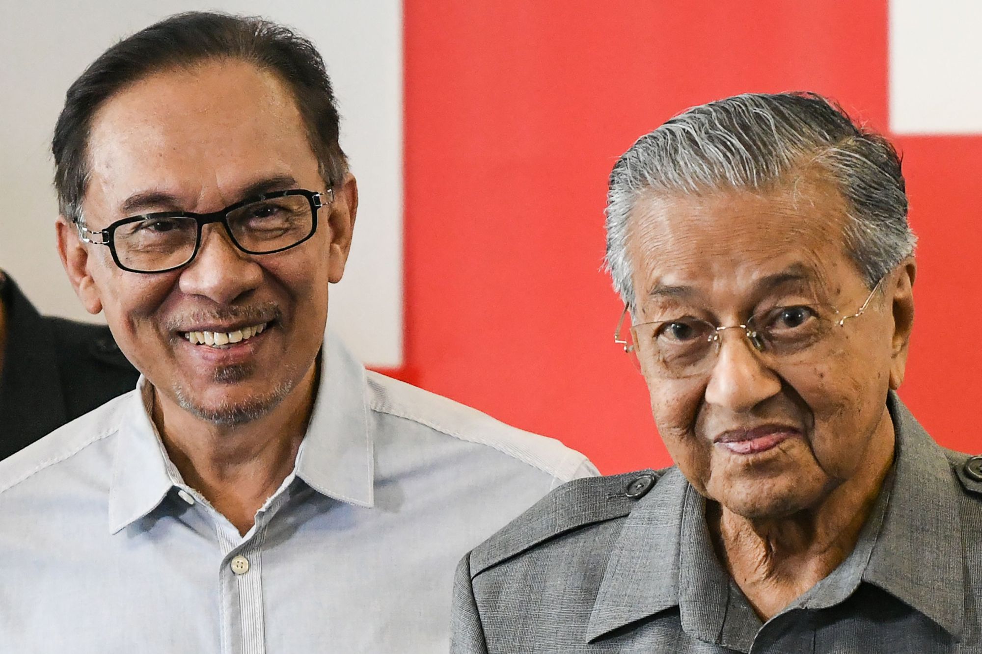 Malaysia's Prime Minister Mahathir Mohamad (right) and his one-time ally Anwar Ibrahim leave a news conference in Kuala Lumpur in June 2018. Mahathir kicked off a leadership race after he abruptly submitted his resignation to the king on Monday. | AFP-JIJI