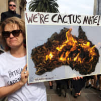 A woman takes part in a protest to call for action on climate change in Melbourne. | REUTERS