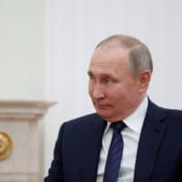 Russian President Vladimir Putin attends a meeting with his Kyrgyz counterpart, Sooronbay Jeenbekov, at the Kremlin in Moscow Thursday. | REUTERS