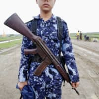 A Myanmar police officer poses for a photograph in Maungdaw, Rakhine state, in 2019. | REUTERS
