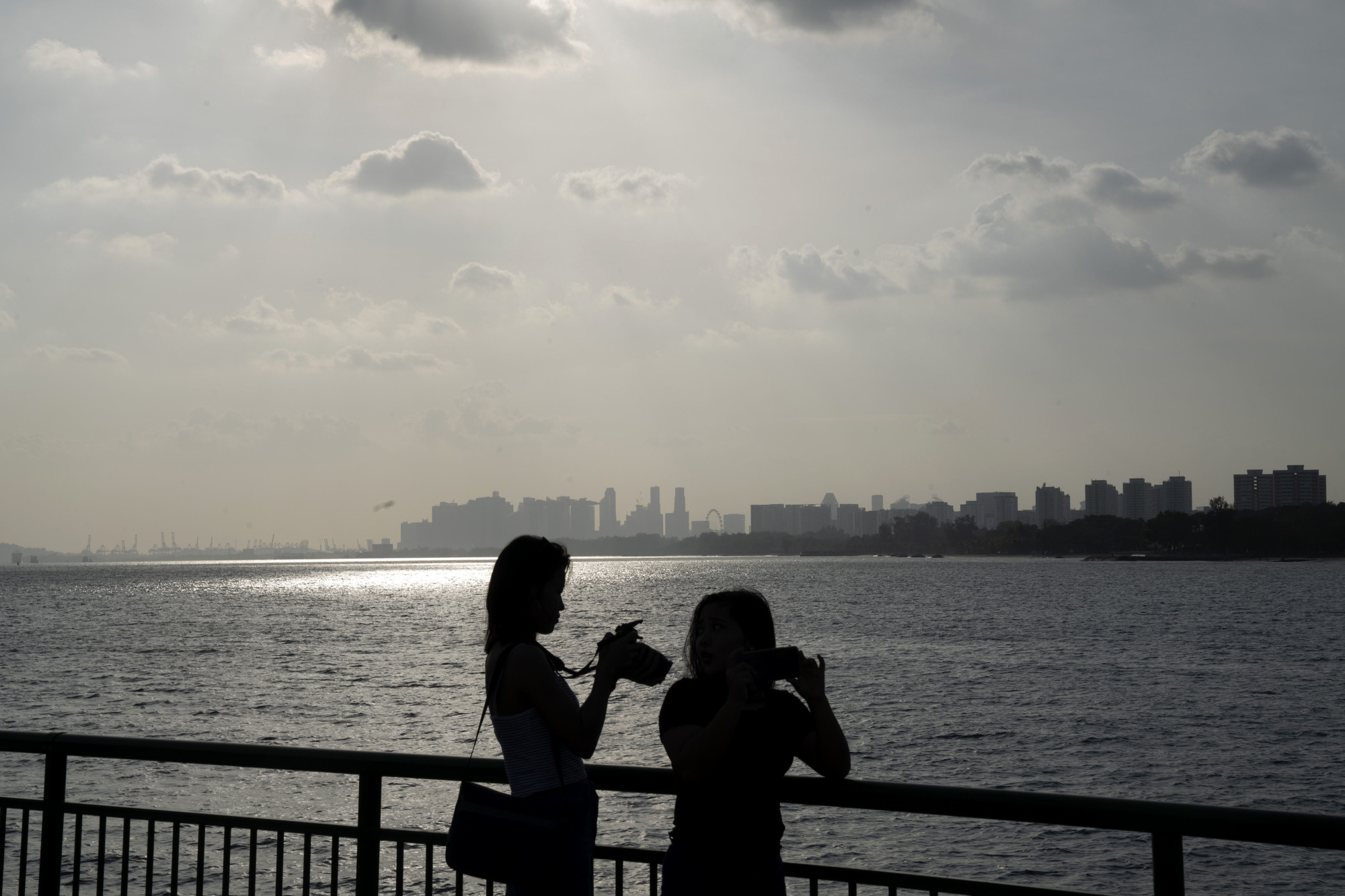Singapore's business district lies across the water from Bedok Jetty at the East Coast Park, built on reclaimed land. | BLOOMBERG