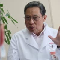 Zhong Nanshan, head of the National Health Commission\'s team investigating the novel coronavirus outbreak, speaks during an interview in Guangzhou on Tuesday. | REUTERS