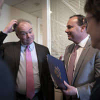 Sens. Tim Kaine (center left) and Mike Lee, flanked by Dick Durbin (left) and Susan Collins, meet prior to a news conference just after the Senate advanced a bipartisan resolution asserting that President Donald Trump must seek approval from Congress before engaging in further military action against Iran, at the Capitol in Washington Wednesday. | AP