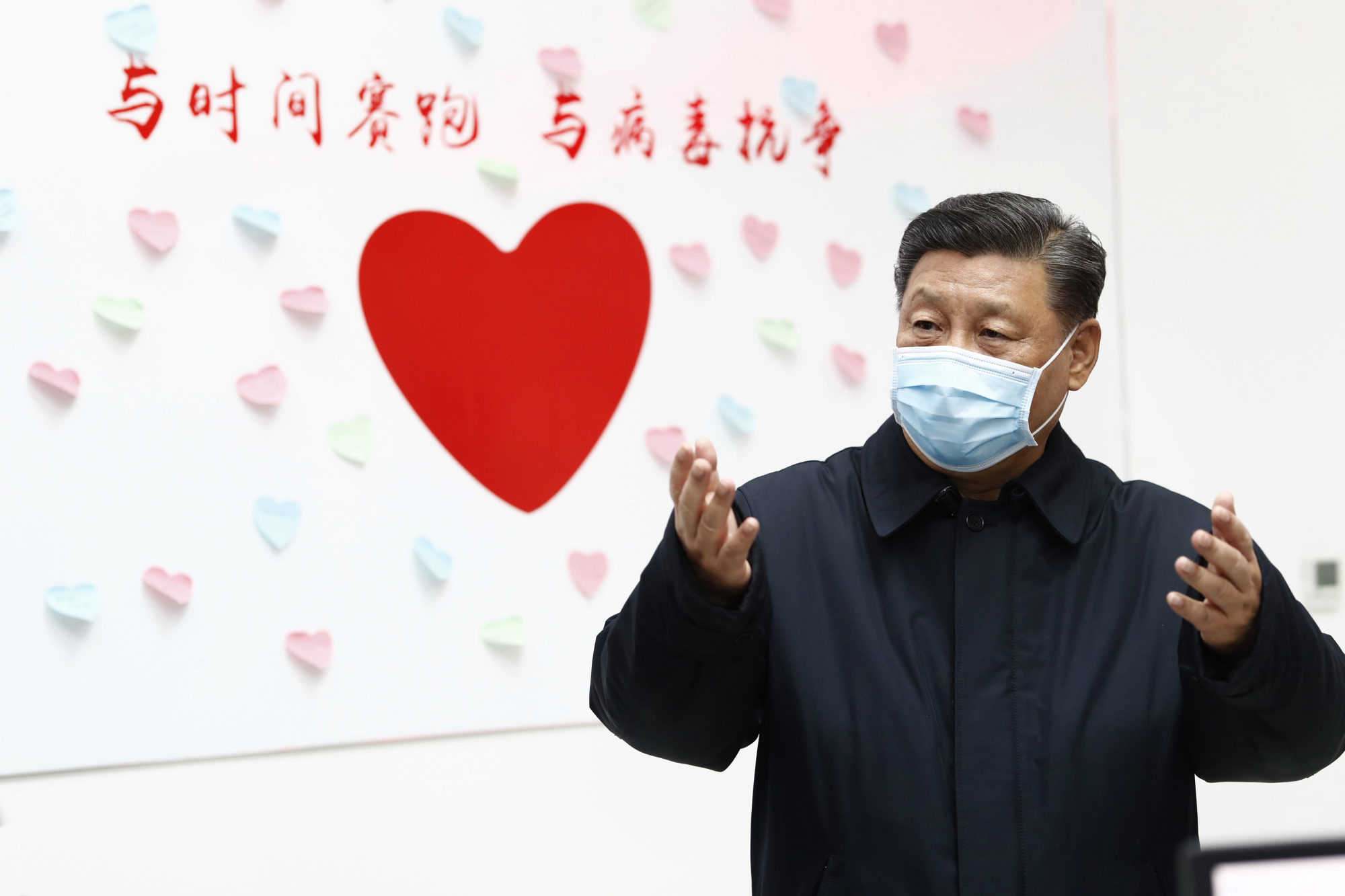 Chinese leader Xi Jinping gestures near a sign that says 'Race against time, Fight the Virus' during an inspection of the center for disease control and prevention of Chaoyang District in Beijing on Feb. 10. | XINHUA / VIA AP