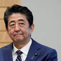 Prime Minister Shinzo Abe listens to IAEA Director General Rafael Grossi at the prime minister\'s official residence in Tokyo Tuesday. | REUTERS