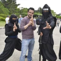 A Turkish man poses for a photo with a group of ninja at Nagoya Castle in Nagoya, Aichi Prefecture. | KYODO